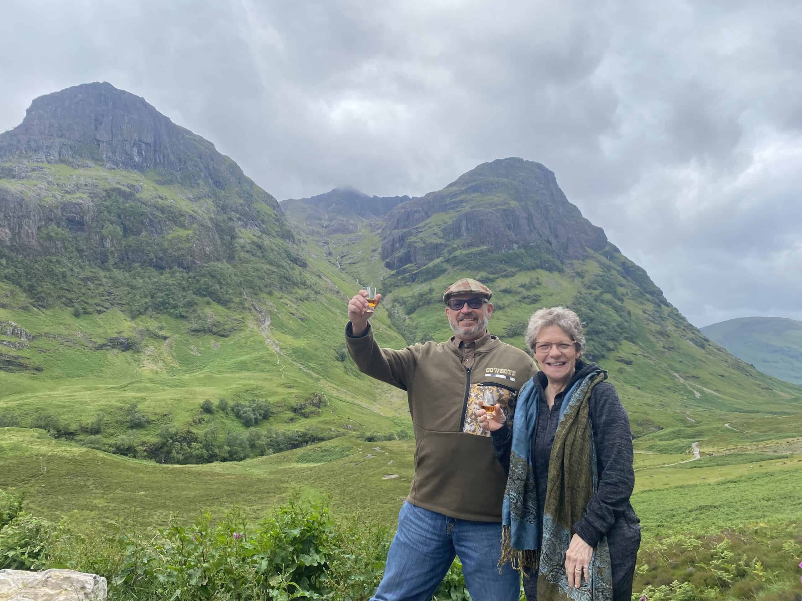 greg and sarita at glencoe holding a whisky